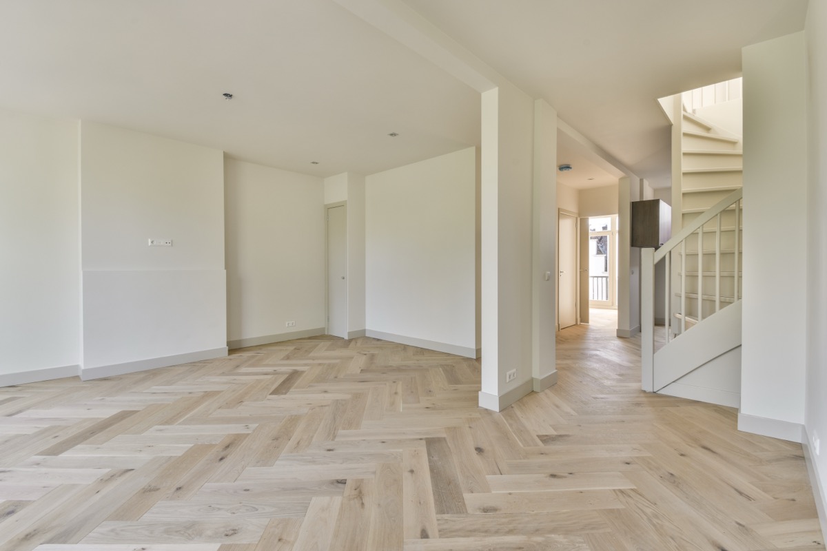 Bright spacious living room with herringbone wood flooring