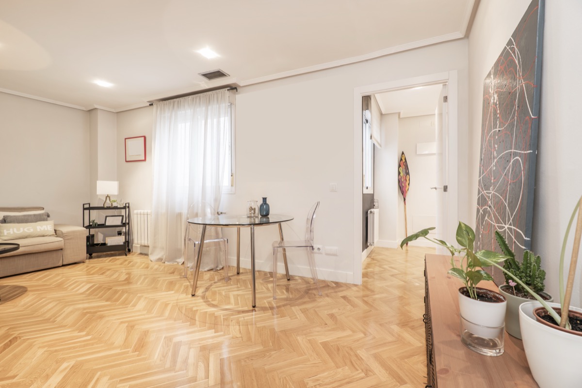 Dining area with glass table on French oak parquet