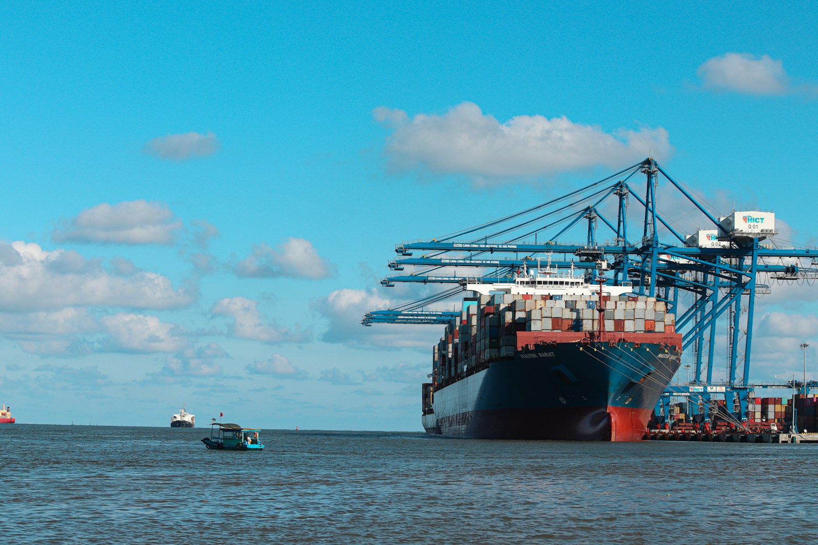 Container ship alongside port cranes