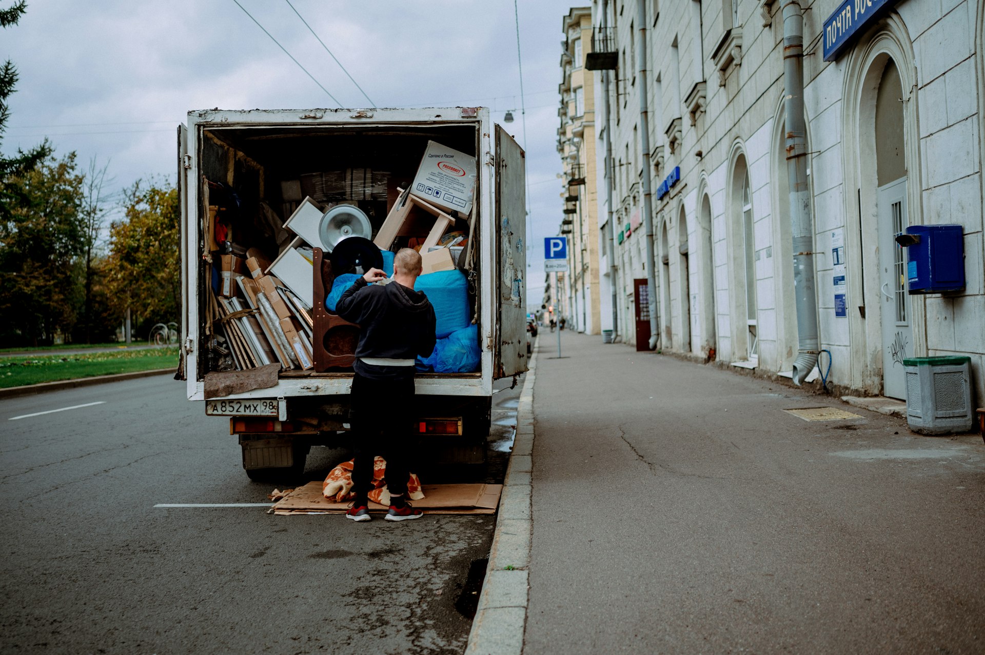 Movers unloading a truck on a city street