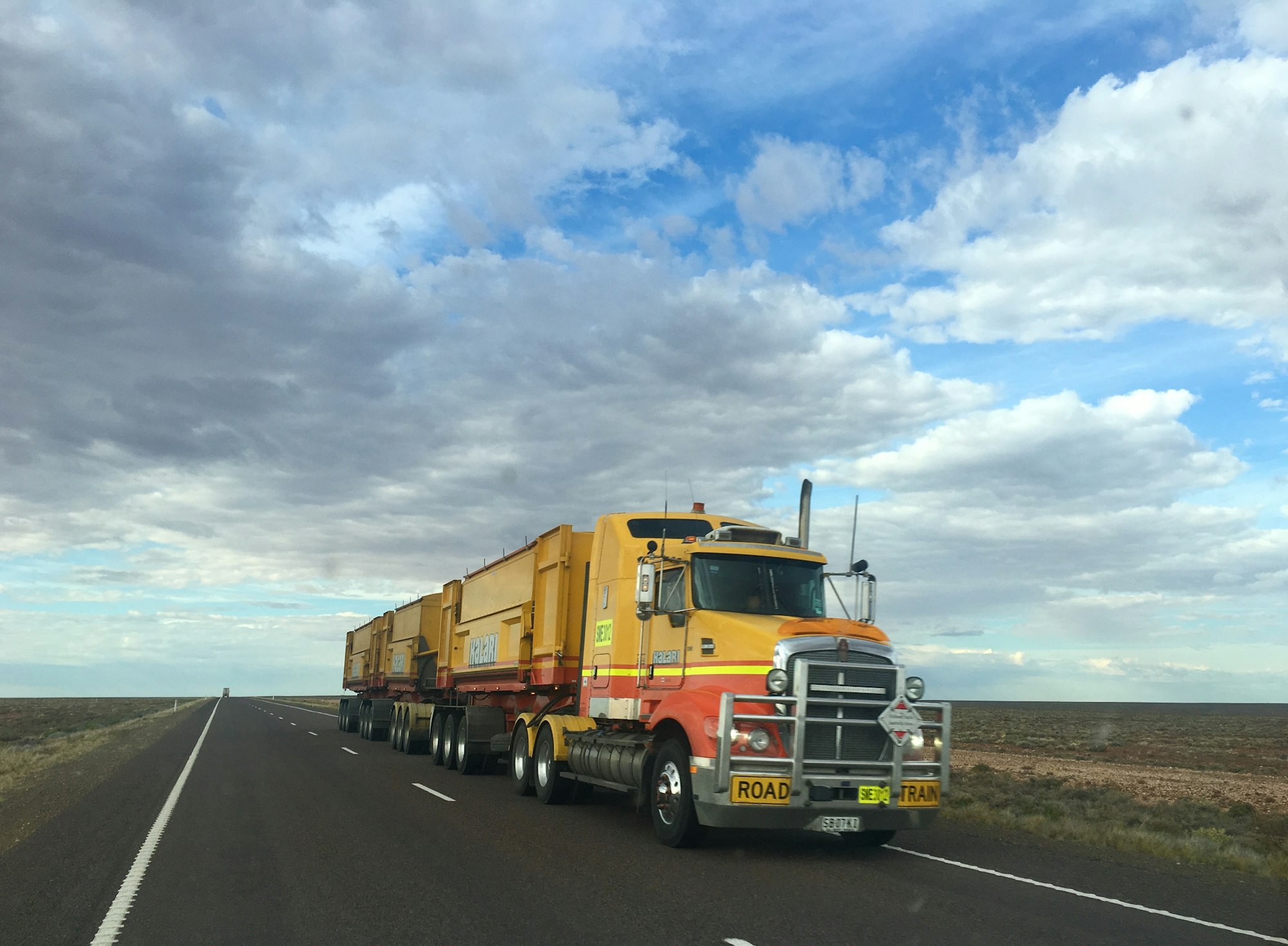 Road train hauling freight across open country