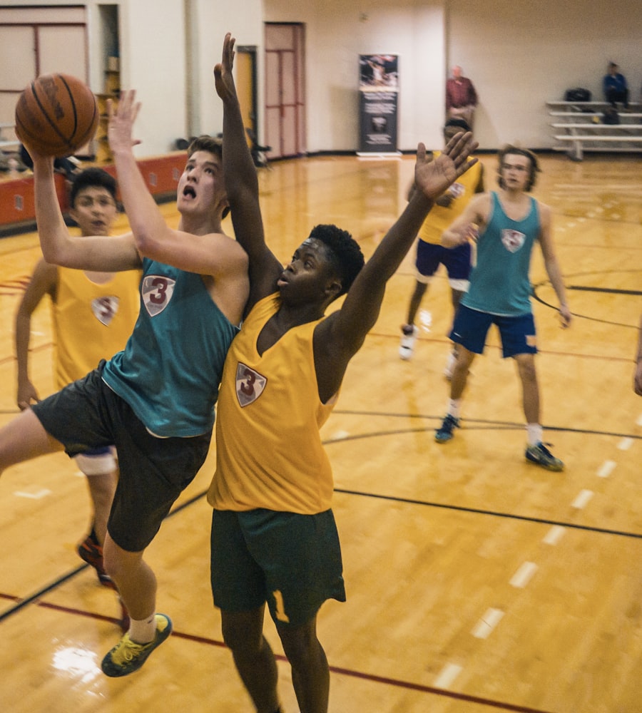Kids mid-air going for a layup during a junior basketball game