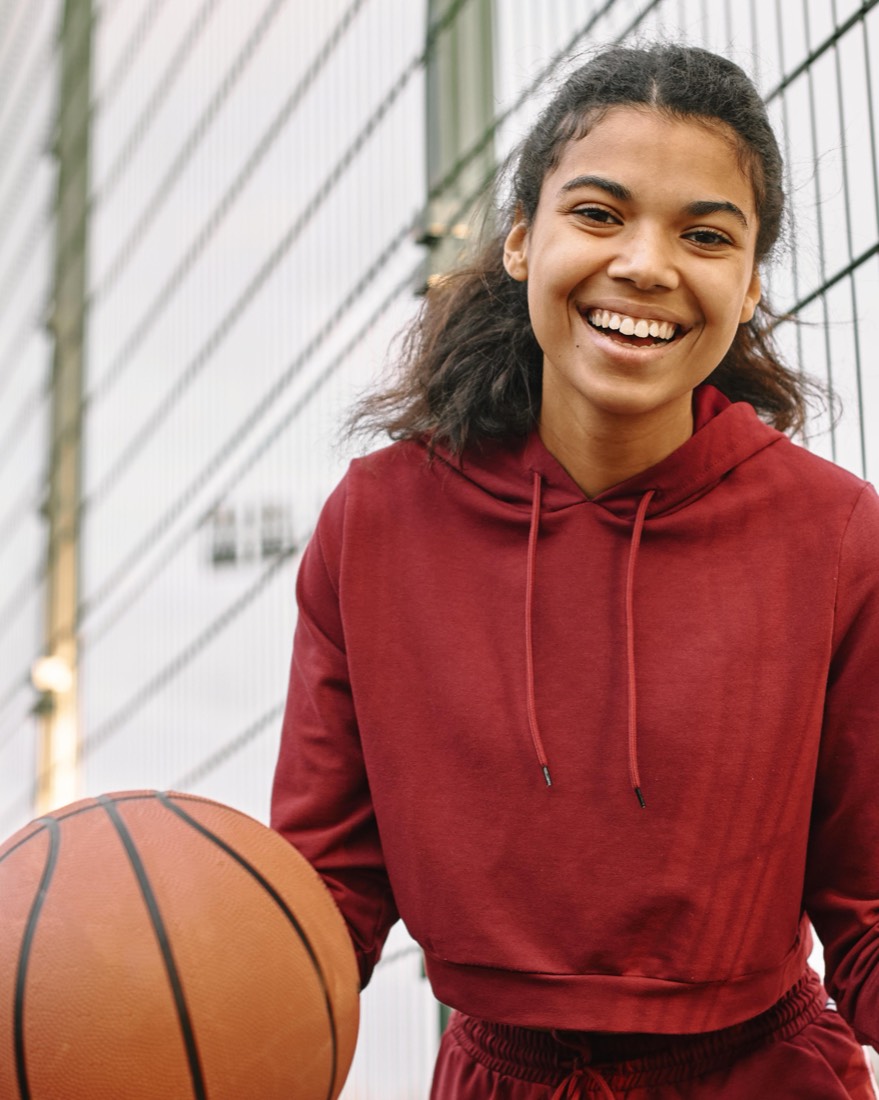Basketball coach holding a ball and smiling