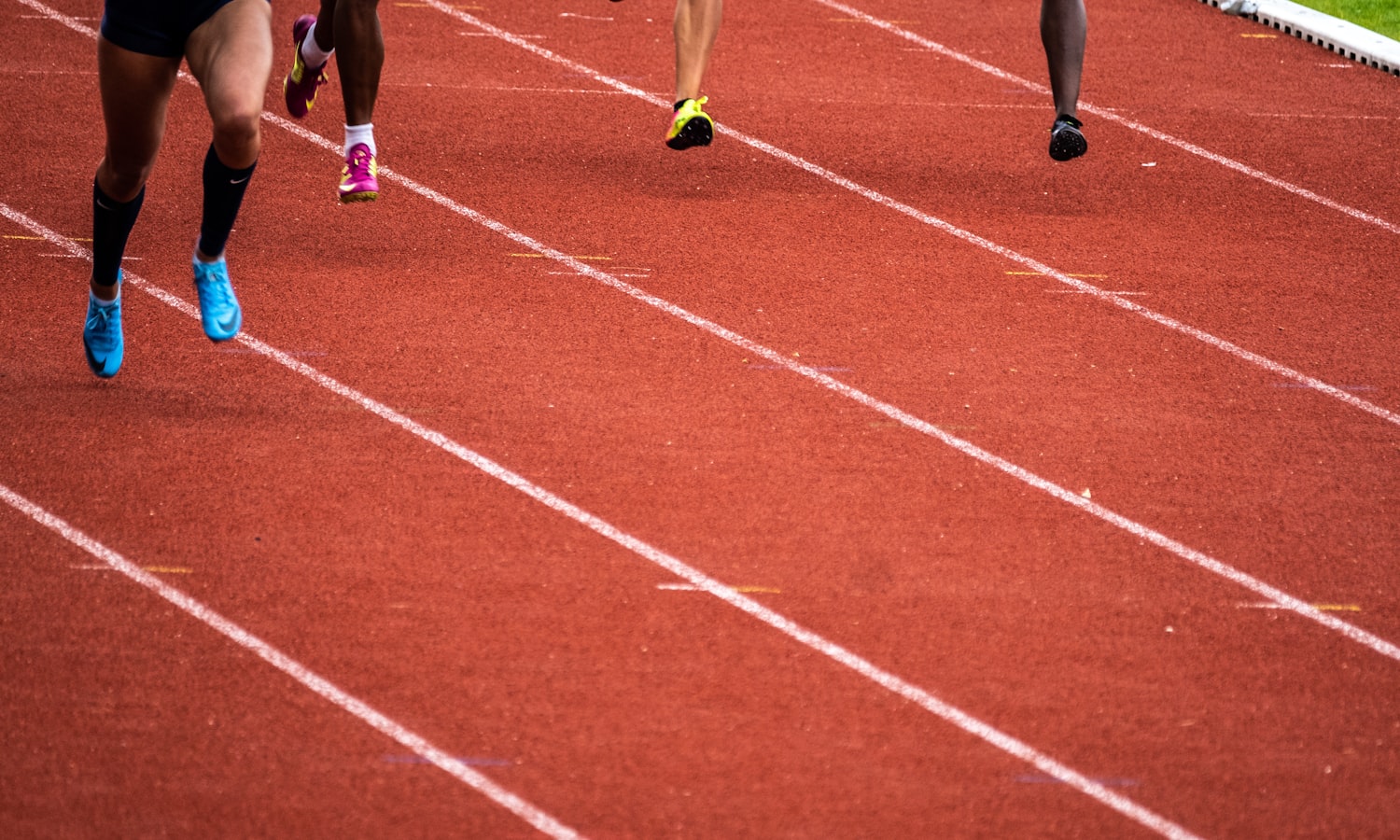 Runners on a red athletics track
