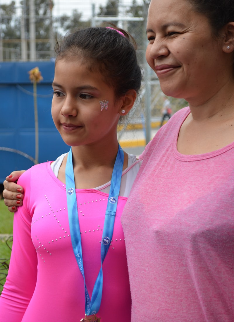 Mother and daughter smiling with a medal