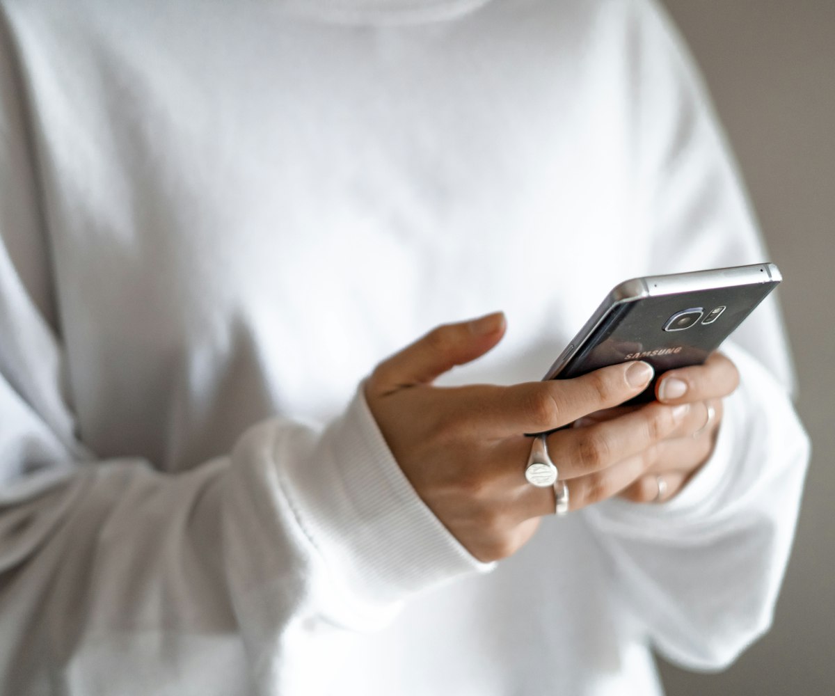 Hand holding a phone with the Vaulta wallet open